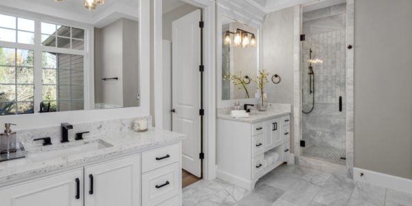Beautiful bathroom in new luxury home with two vanities, sinks, and mirrors.