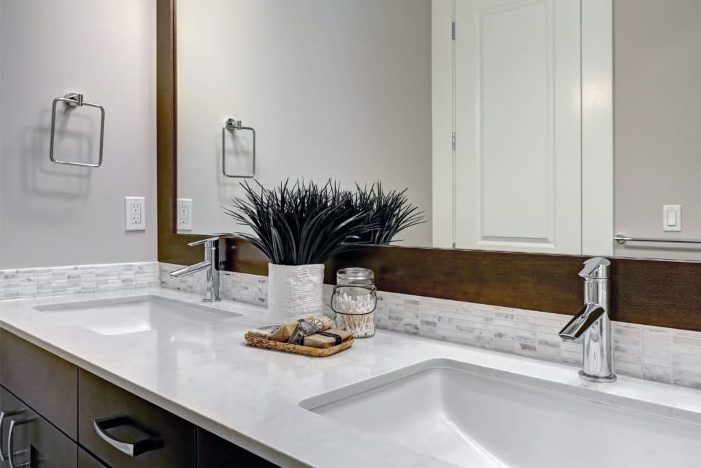 White,And,Brown,Bathroom,Boasts,A,Nook,Filled,With,Double counters and cabinet